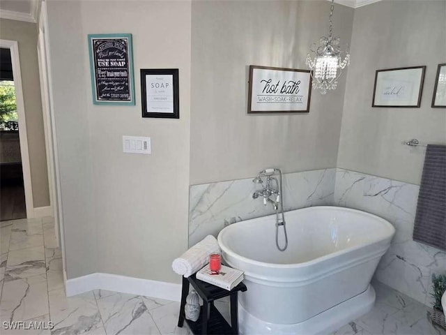 bathroom featuring a bath, a notable chandelier, and ornamental molding