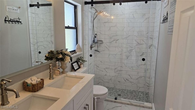 bathroom featuring vanity, toilet, and a tile shower