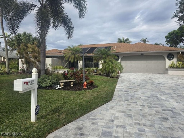 view of front facade with a garage and a front yard