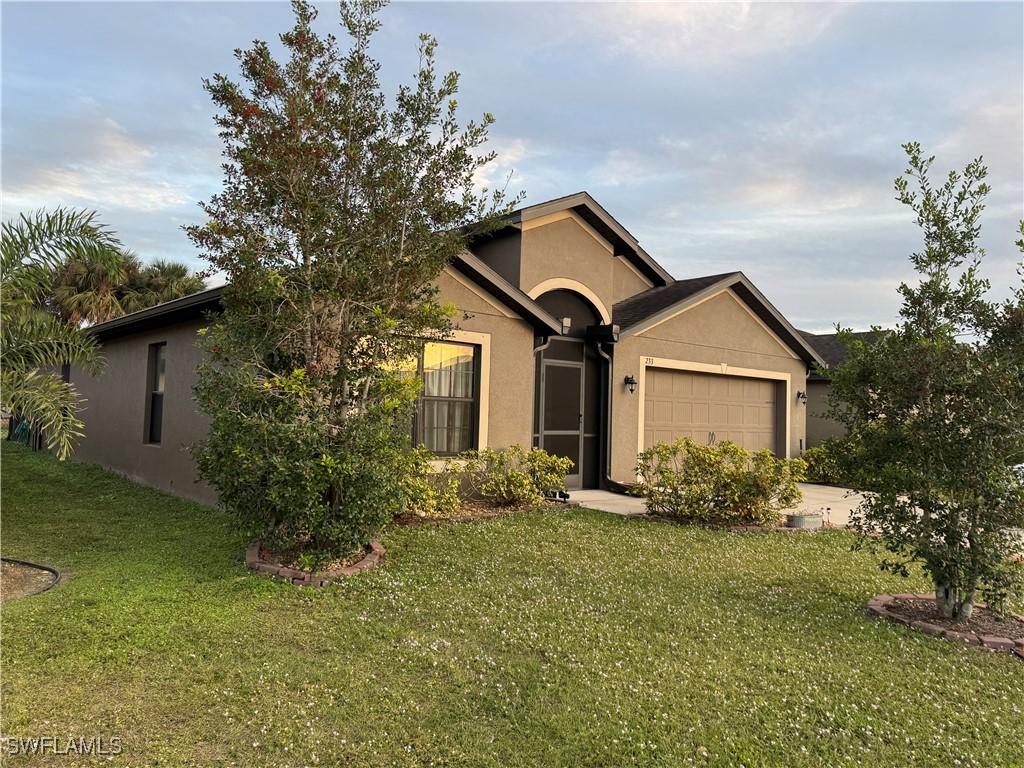 ranch-style home with a front lawn and a garage