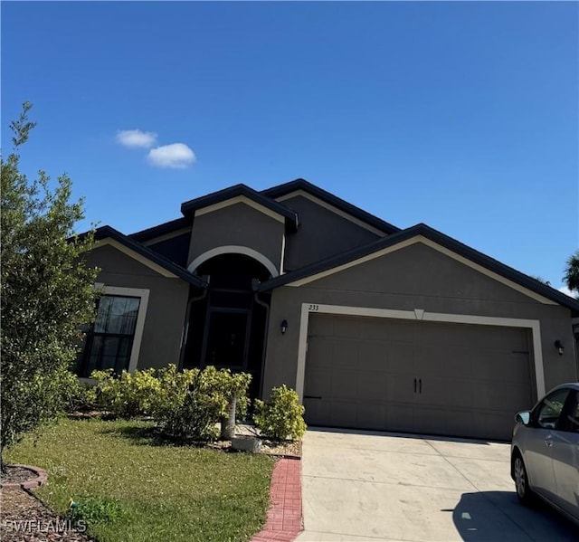 ranch-style home with a garage and a front yard