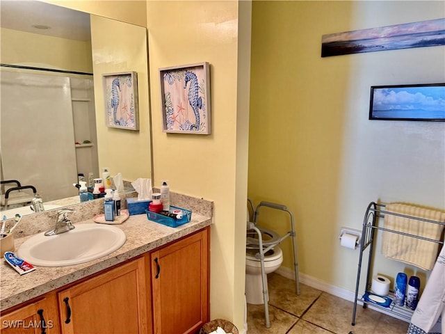 full bathroom with toilet, tile patterned flooring, baseboards, and vanity