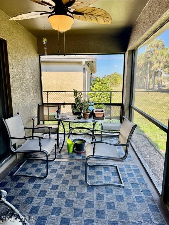 sunroom featuring a ceiling fan