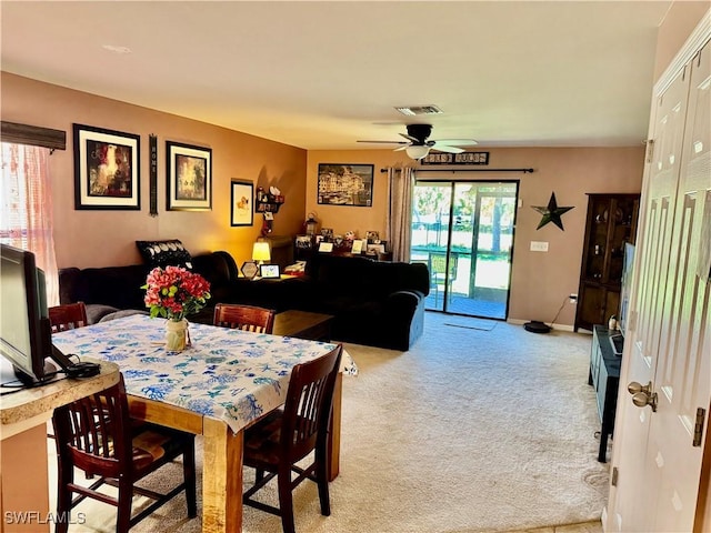 dining area featuring light carpet, baseboards, visible vents, and a ceiling fan