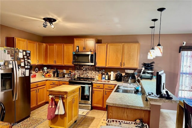 kitchen featuring a breakfast bar, pendant lighting, appliances with stainless steel finishes, butcher block countertops, and a peninsula