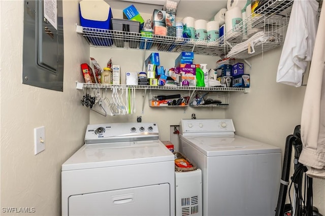 clothes washing area featuring washing machine and dryer and electric panel