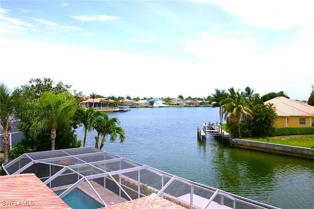 dock area with a lanai and a water view