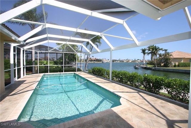 view of pool with a lanai and a water view