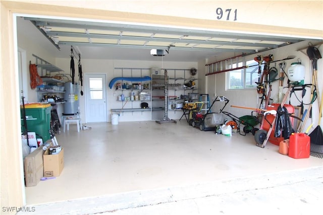 garage featuring strapped water heater and a garage door opener