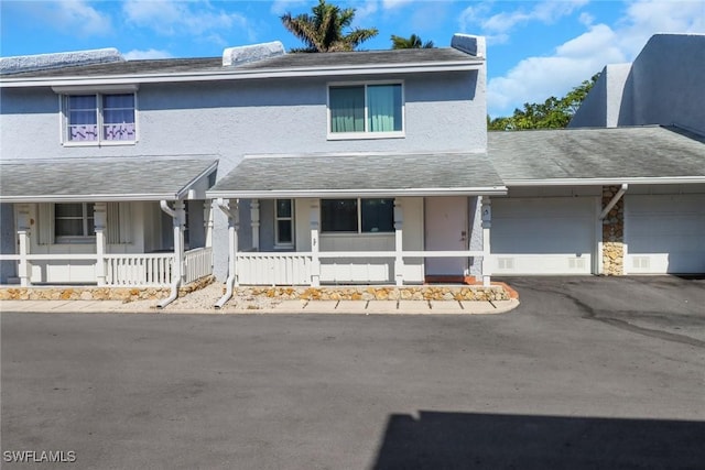 view of property featuring a garage and a porch