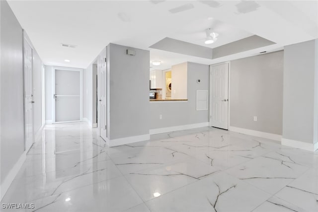 spare room featuring ceiling fan and a tray ceiling