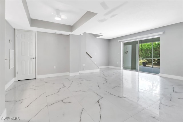 unfurnished room featuring a raised ceiling