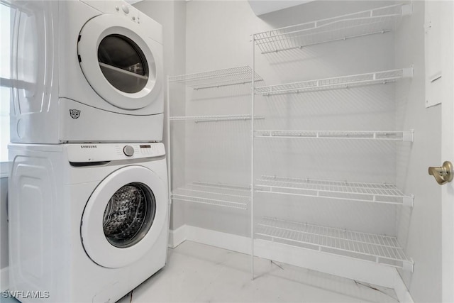 laundry room featuring stacked washer / dryer