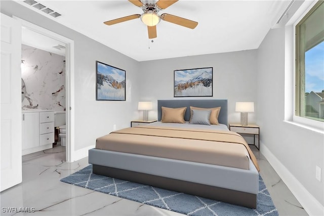 bedroom with ceiling fan and ensuite bath