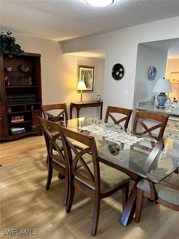 dining space featuring light wood finished floors