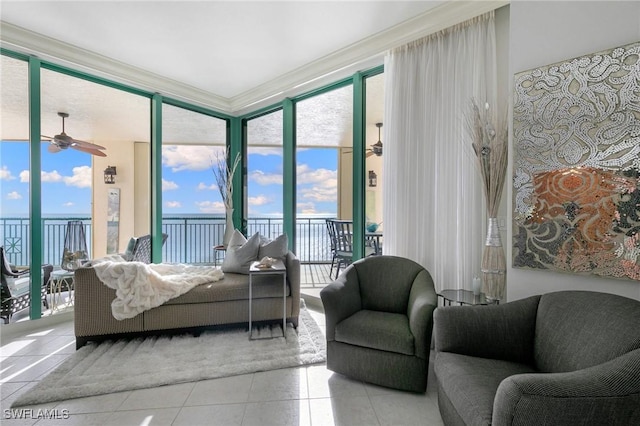 living room featuring a wall of windows, plenty of natural light, ceiling fan, and tile patterned flooring