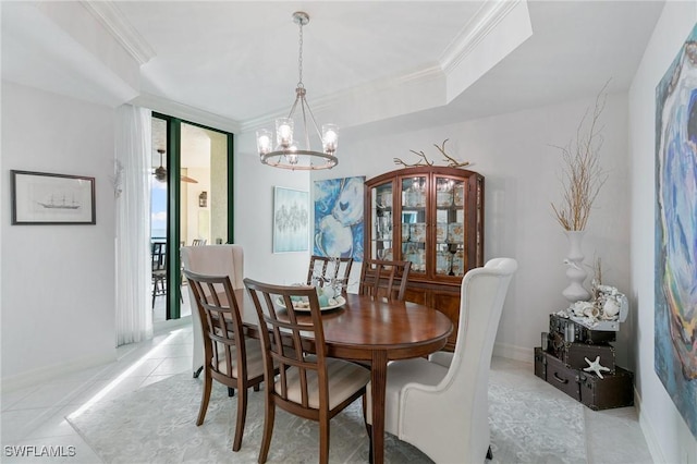 dining space with light tile patterned floors, baseboards, crown molding, a raised ceiling, and a chandelier