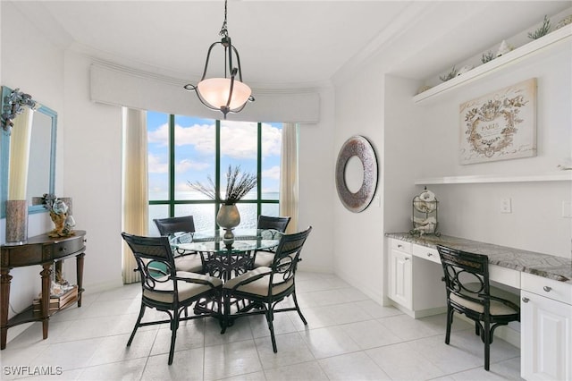 dining room with light tile patterned flooring, crown molding, and built in study area