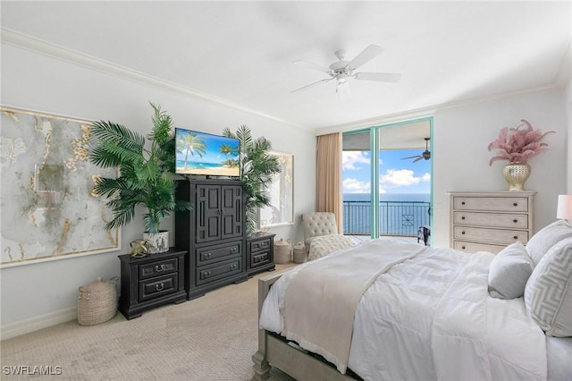 carpeted bedroom featuring access to exterior, a ceiling fan, baseboards, and ornamental molding