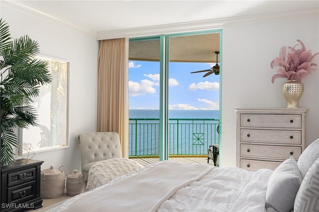 bedroom with access to exterior, floor to ceiling windows, crown molding, and a water view