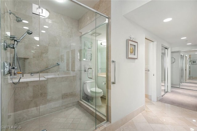 full bathroom featuring recessed lighting, a shower stall, and baseboards