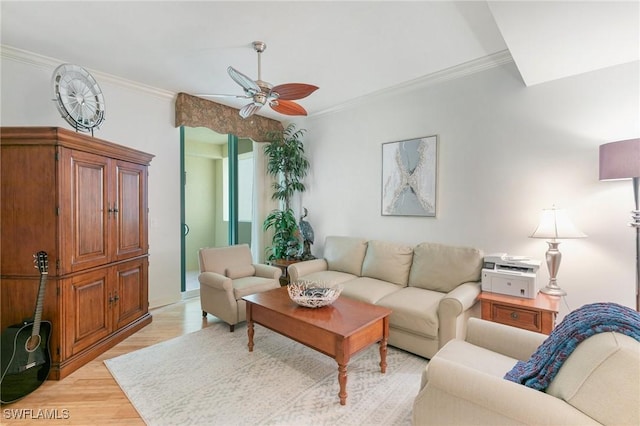 living room with ceiling fan, light wood-type flooring, and ornamental molding