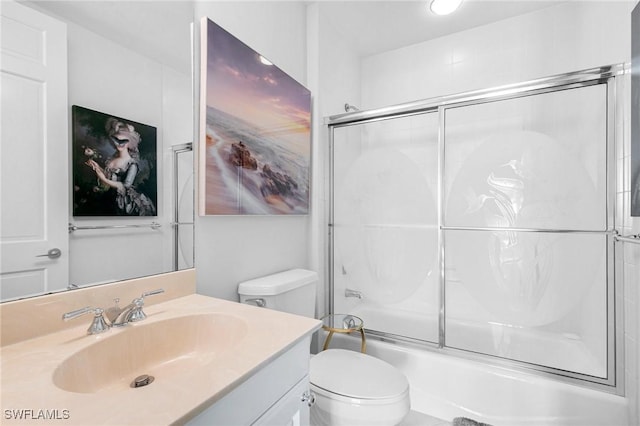 bathroom with shower / bath combination with glass door, toilet, and vanity