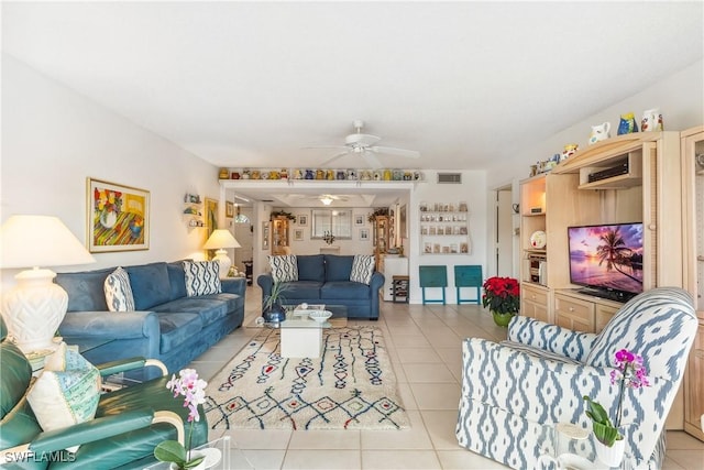 tiled living room featuring ceiling fan