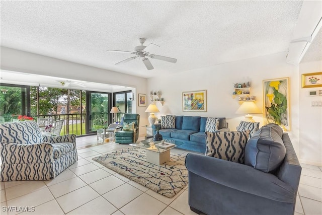 living room featuring light tile patterned flooring, a textured ceiling, and ceiling fan