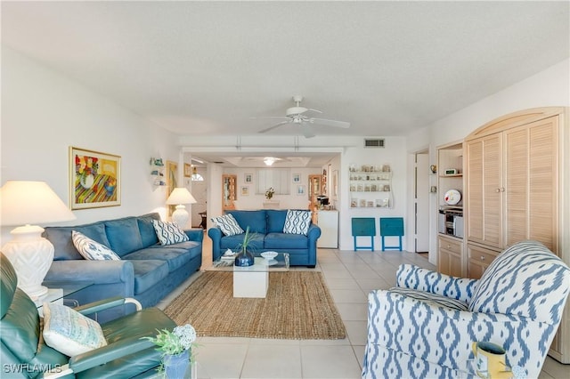 1760 Bald Eagle Dr Unit 506B, Naples, FL 34105 - tiled living area featuring a ceiling fan and a textured ceiling