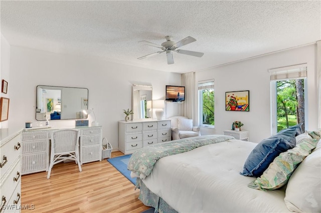 1760 Bald Eagle Dr Unit 506B, Naples, FL 34105 - bedroom featuring wood finished floors, a textured ceiling, and ceiling fan