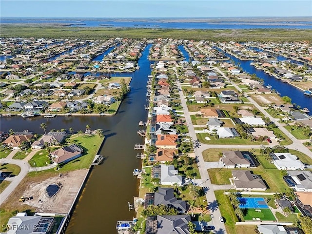 drone / aerial view featuring a residential view and a water view