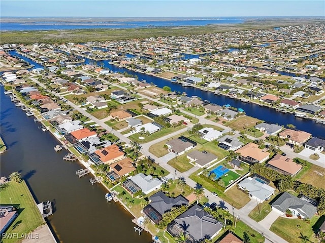 birds eye view of property featuring a water view and a residential view