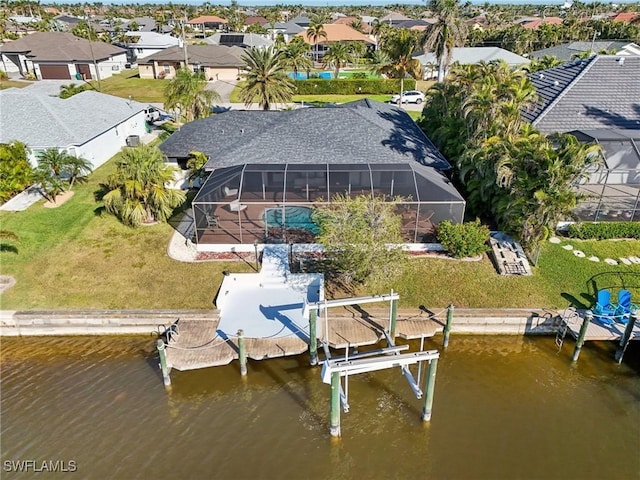 drone / aerial view featuring a residential view and a water view