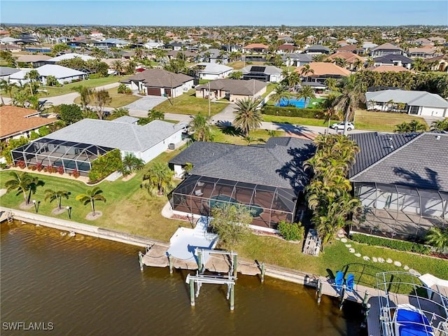 birds eye view of property featuring a water view and a residential view