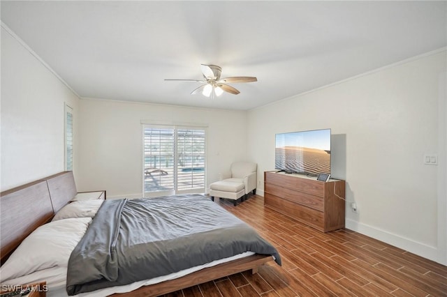 bedroom featuring ceiling fan, ornamental molding, and wood-type flooring