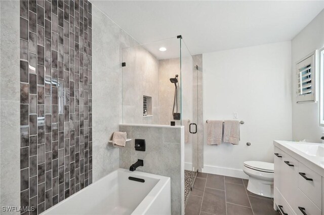 bathroom featuring tile patterned flooring, vanity, and toilet