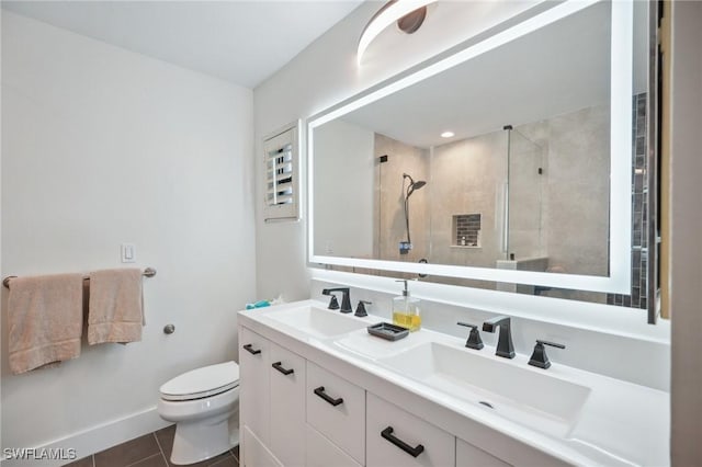 bathroom featuring tile patterned flooring, an enclosed shower, vanity, and toilet