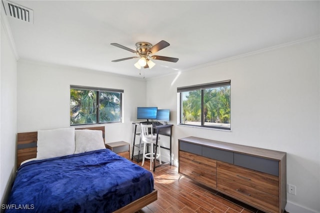 bedroom with ornamental molding and ceiling fan