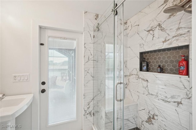 bathroom with a shower with door