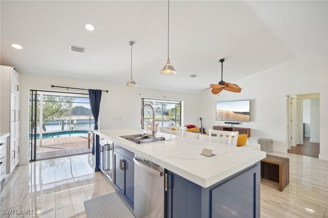 kitchen featuring visible vents, lofted ceiling, a sink, pendant lighting, and stainless steel dishwasher