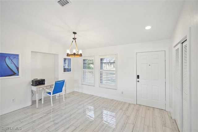 unfurnished office featuring an inviting chandelier and vaulted ceiling