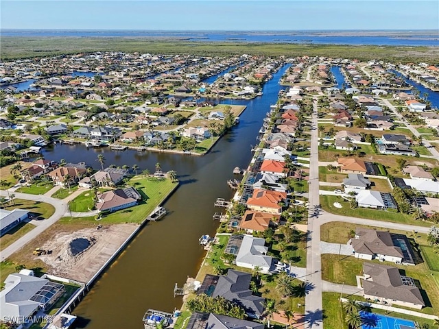 drone / aerial view with a water view and a residential view