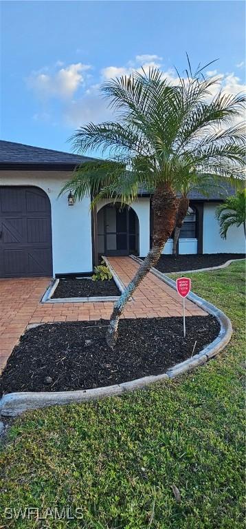 exterior space with decorative driveway and an attached garage