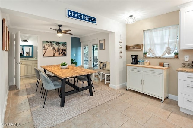 dining room featuring ceiling fan, french doors, and ornamental molding