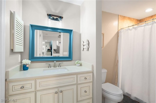 bathroom featuring vanity, toilet, and walk in shower