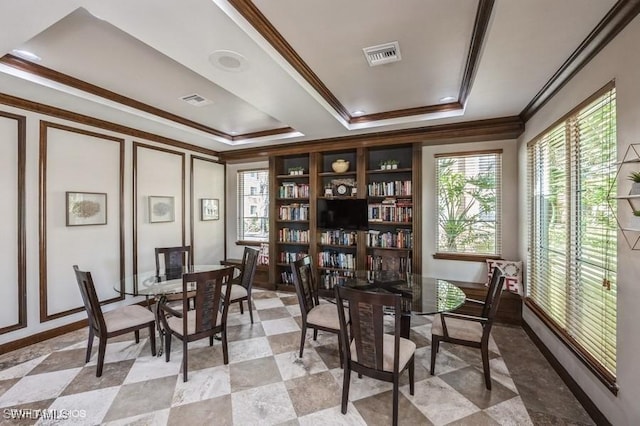 living area featuring crown molding and a raised ceiling