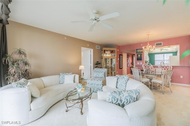 living room featuring carpet flooring and ceiling fan with notable chandelier