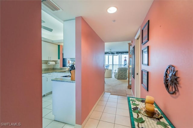 hallway featuring light tile patterned flooring