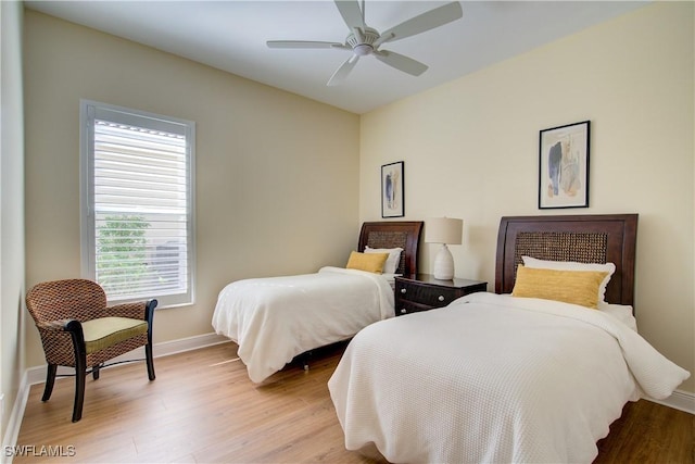 bedroom with light hardwood / wood-style floors and ceiling fan